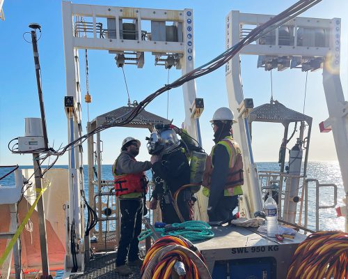 divers working on cable installation